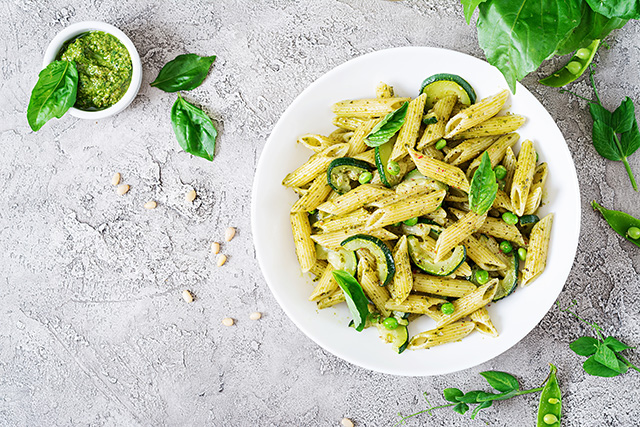 penne-pasta-with-pesto-sauce-zucchini-green-peas-and-basil-italian-food-top-view-flat-lay